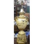 A MARBLED TABLE LAMP in the form of an urn with ram's head handles, 61cm high (plus fitting) and