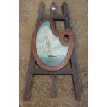 AN EDWARDIAN PAINTED EASEL with a palette painted with a sailing boat, 103cm high
