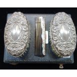 A PAIR OF SILVER BACKED DRESSING BRUSHES