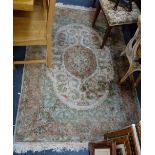 A CREAM GROUND SILK RUG, 125cm wide x 180cm long (plus fringes)