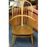 ERCOL; A HOOP BACK WINDSOR ARMCHAIR in pale elm and beech