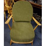 ERCOL; A PALE BEECH ARMCHAIR with green cushions