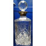 A CUT GLASS WHISKY DECANTER with a silver collar