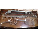 AN ANTIQUE WROUGHT IRON GRIDDLE, a pot hook, pan stand and two pan hanging racks