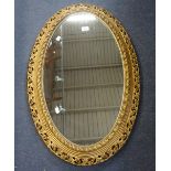 AN OVAL GILT FRAMED MIRROR