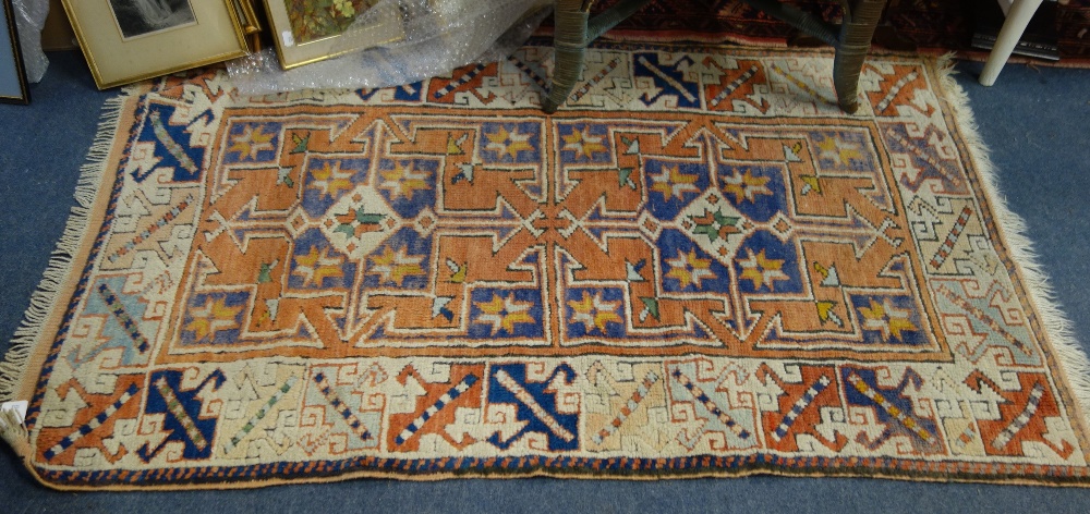 A SMALL AZTEC DESIGN RUG, 82cm x 136cm (plus fringes)