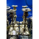 A SET OF FOUR SILVER PLATED CANDLESTICKS, 24cm high