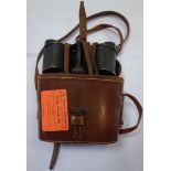 A PAIR OF BINOCULARS by Hartill in a leather case, with a paper label, 'The Royal St George's Golf