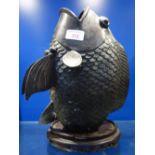 AN ORIENTAL PATINATED BRONZE STUDY OF A FISH, 29cm high on a wooden base