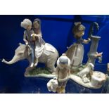 LLADRO; A STUDY OF FIGURES on the back of an elephant, a girl with a water pump and a boy with a