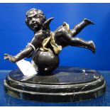A PATINATED BRONZE STUDY OF A CHERUB on a polished black marble base