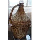 A GLASS FLAGON with original wicker cover and handle