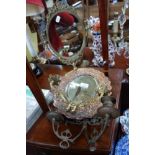 A REPOUSSE COPPER AND BRASS WALL SCONCE, another similar and a brass table mirror