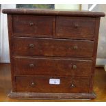 AN OAK MINIATURE CHEST OF DRAWERS, 33.5cm wide