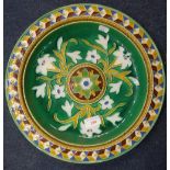 A VICTORIAN MINTON MAJOLICA DISH decorated with lilies, 36cm dia. (repaired)