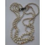 A THREE STRAND SIMULATED PEARL NECKLACE, with three rows of graduating pearls and paste set clasp