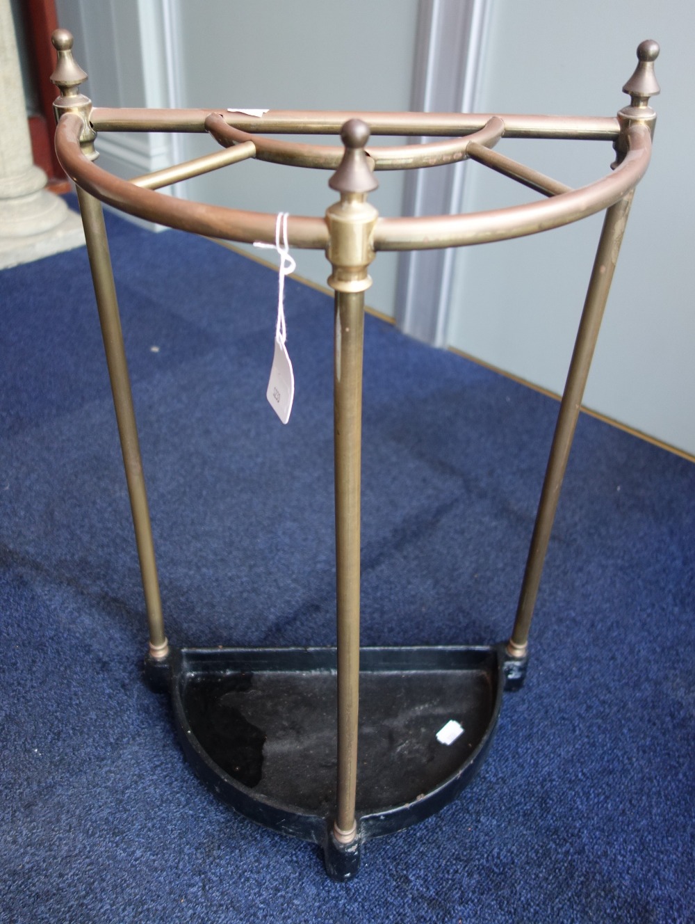 A VICTORIAN STYLE TUBULAR BRASS AND CAST IRON UMBRELLA STAND