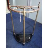 A VICTORIAN STYLE TUBULAR BRASS AND CAST IRON UMBRELLA STAND