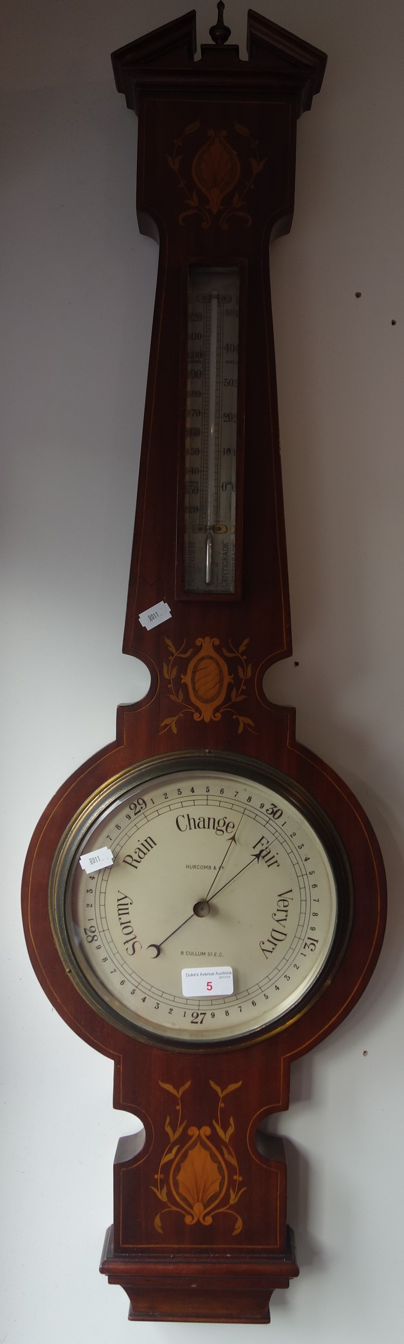 AN EDWARDIAN MAHOGANY CASED ANEROID BAROMETER AND THERMOMETER by Hurcomb & Co, London