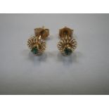 A PAIR OF 18K GOLD EAR STUDS, both set with small round cut emerald to the centre