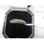 A FIVE STONE GYPSY STYLE RING, on an 18ct yellow gold shank, ring size O