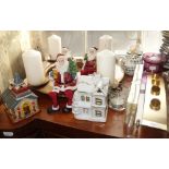 A GILT TABLE CENTREPIECE with four candles, a collection of Father Christmas ornaments, candle