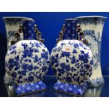 A PAIR OF VICTORIAN BLUE AND WHITE 'MOON FLASK' VASES, 23.5cm high and a pair of Delft vases, 24.5cm