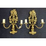 A PAIR OF GILT TWO BRANCH WALL SCONCES moulded with flowers