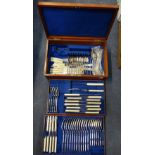 AN EDWARDIAN CANTEEN OF CUTLERY in a fitted mahogany case