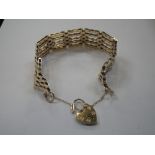 A 9CT GOLD GATELINK BRACELET, with padlock clasp and safety chain, approx. 20gm