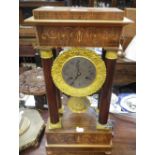 A 19TH CENTURY FRENCH EMPIRE STYLE PORTICO MANTLE CLOCK, the silvered dial with Roman numerals, cast