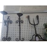 A PAIR OF RUSTIC GOTHIC STYLE WALL CANDLE SCONCES and a similar two branch candlestick