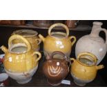 A COLLECTION OF FRENCH YELLOW GLAZED WINE POTS AND OTHER ITEMS