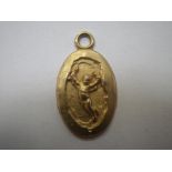 UNMARKED YELLOW METAL PENDANT, engraved with small cherub to one side