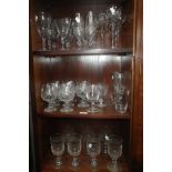 A COLLECTION OF DRINKING GLASSES, including champagne and brandy glasses