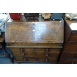 A GEORGE II OAK BUREAU with a fall flap enclosing a fitted interior over a well and an arrangement