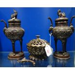 AN ORIENTAL BRONZE CENSER and a pair of similar vases with temple lion finials