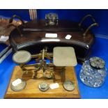 AN EDWARDIAN MAHOGANY INK STAND, a set of brass and oak postal scales and a cut glass inkwell (3)