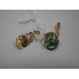 TWO 18K GOLD PENDANTS, one in the form of a mythical beast set with a central square cut emerald.