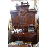 A LARGE 19TH CENTURY CONTINENTAL WALNUT BUFFET, with carved scenes to the upper doors, 266cm high