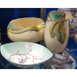 A CLARICE CLIFF VASE, with a yellow glaze, decorated with leaves in relief, a matching bowl (old