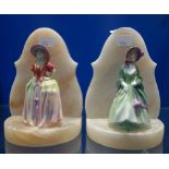 A PAIR OF 1930S ALABASTER BOOKENDS with ceramic ladies in period costume