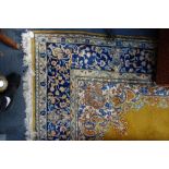 A MUSTARD GROUND ENGLISH CARPET, with a cream and blue floral border, 220cm wide x 310cm long (