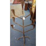 A RUSTIC METAL SEVEN BRANCH CANDLESTICK