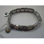 AN EXPANDABLE STAINLESS STEEL LINK BRACELET, decorated with mixed charms including one in the form