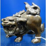 A CHINESE PATINATED BRONZE TEMPLE LION
