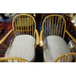 ERCOL; A NEAR PAIR OF PALE BEECH ARMCHAIRS with grey seat cushions