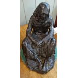 A 20TH CENTURY PATINATED BRONZE in the form of a seated figure signed "Dailey", 28cm high