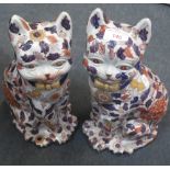 A PAIR OF CHINESE CERAMIC CATS with allover floral design, 38cm high