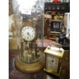 AN ANNIVERSARY CLOCK UNDER A GLASS DOME and a brass carriage clock